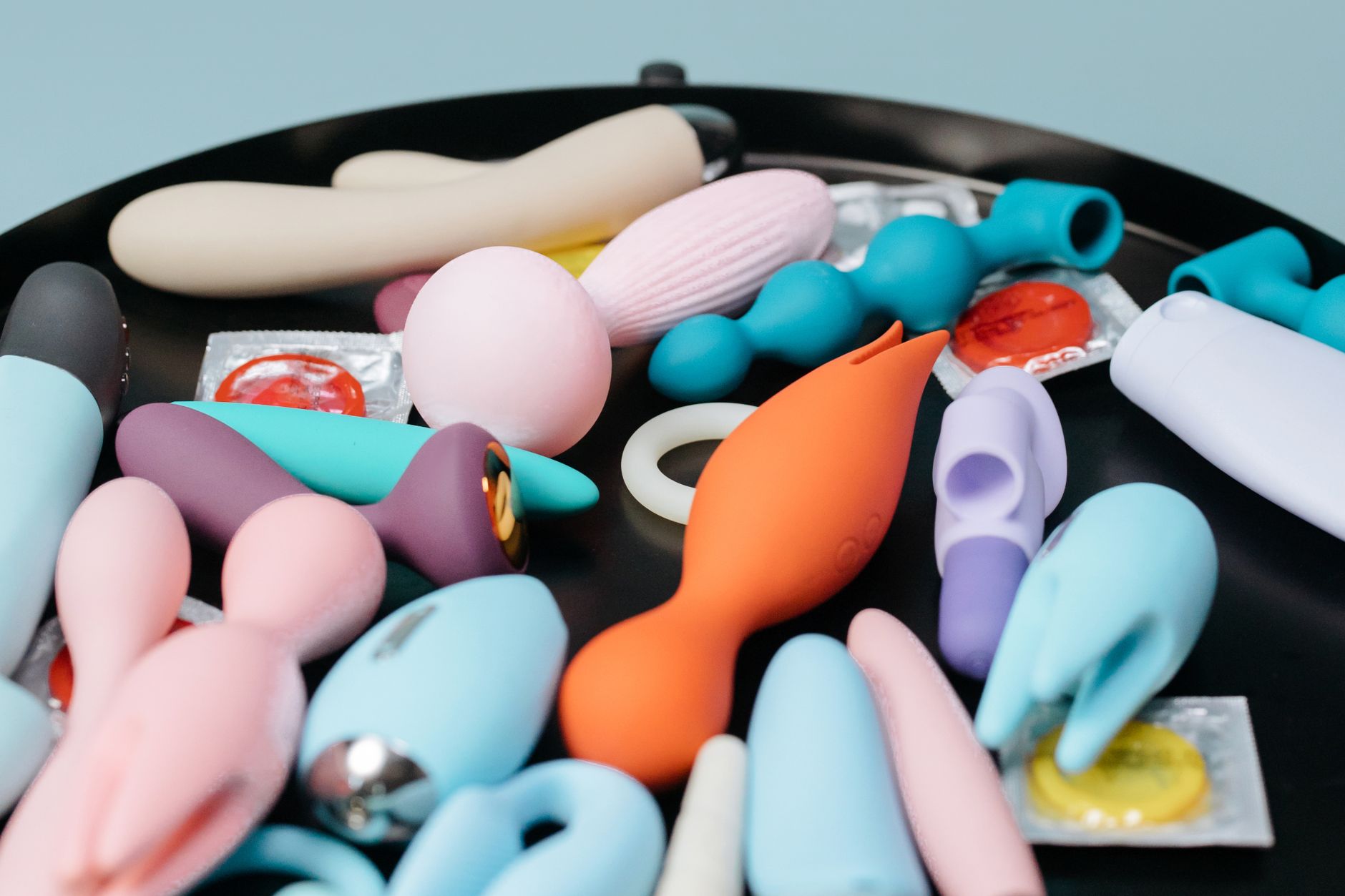A vibrant collection of lemon clitoral vibrators and adult toys displayed on a black surface
