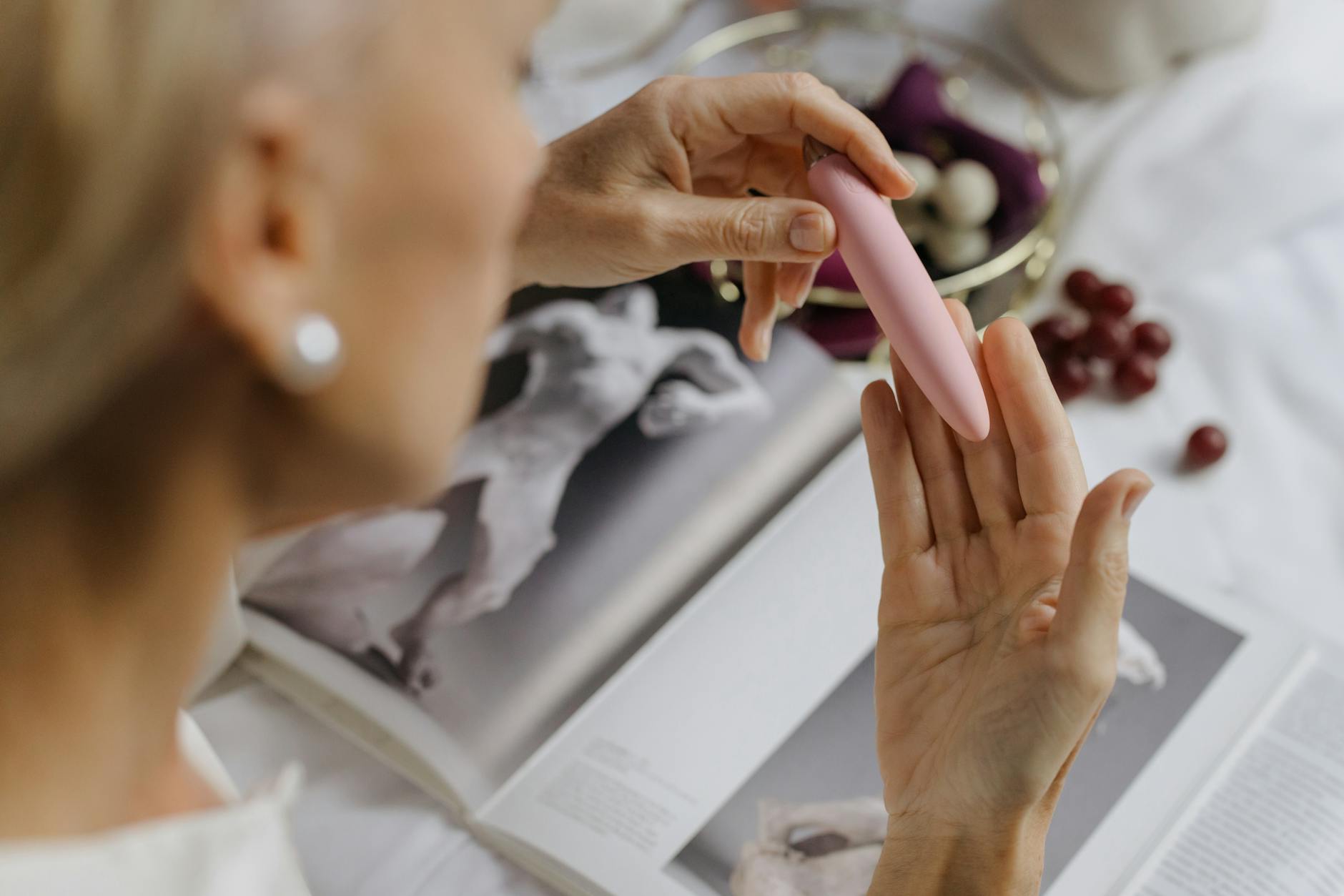Close-up of hands holding a lemon clitoral vibrator, emphasizing intimate personal exploration during life transitions.