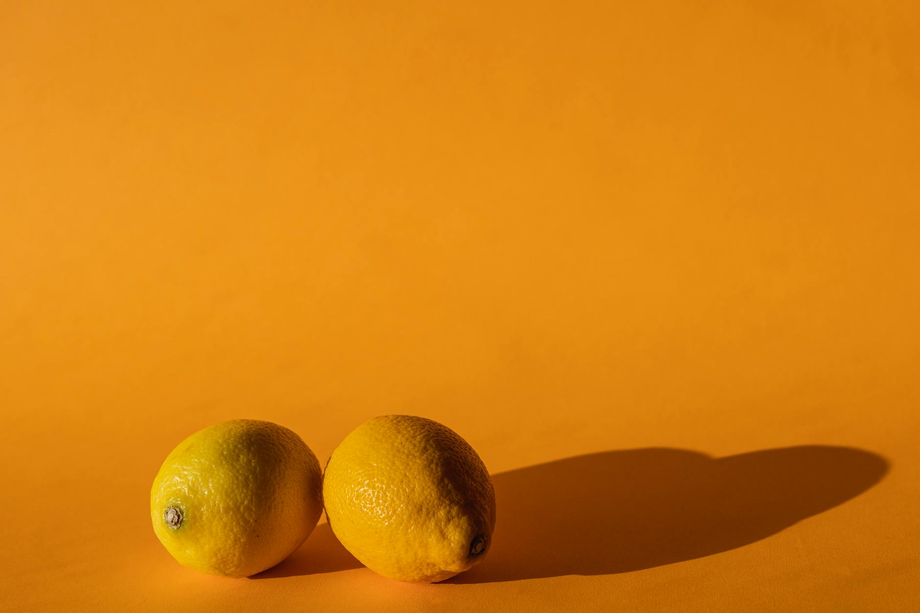 Ripe vivid lemons composed on yellow background representing fresh approach to pleasure